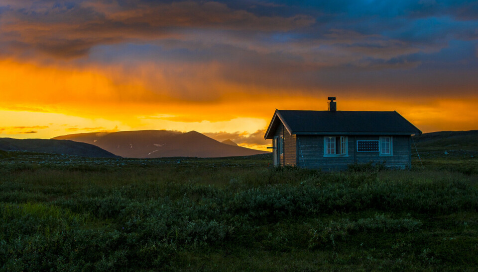 Statskogs åpne koie ved innsjøen Stor-Rosta, i Dividalen nasjonalpark i Indre Troms. Solnedgang og dramatisk himmel.